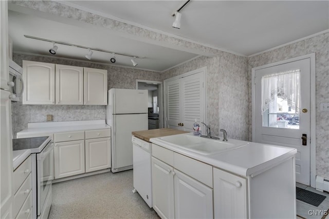 kitchen with sink, white appliances, baseboard heating, white cabinetry, and ornamental molding