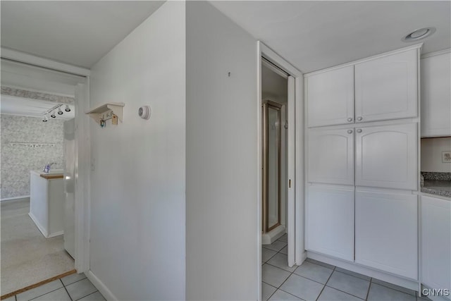 corridor with light tile patterned floors