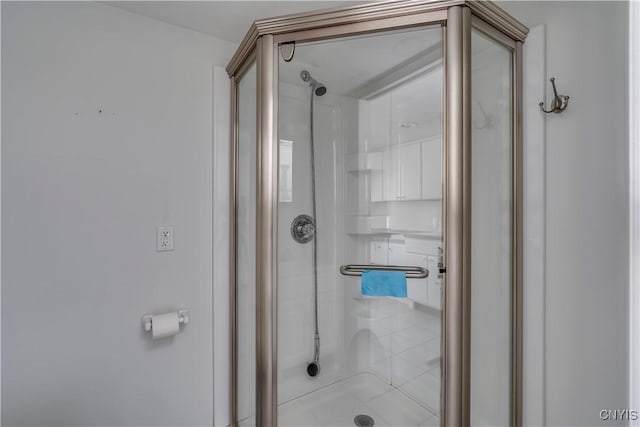 bathroom featuring a shower with door