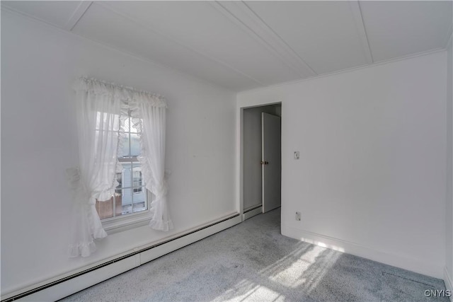 carpeted spare room featuring a baseboard heating unit