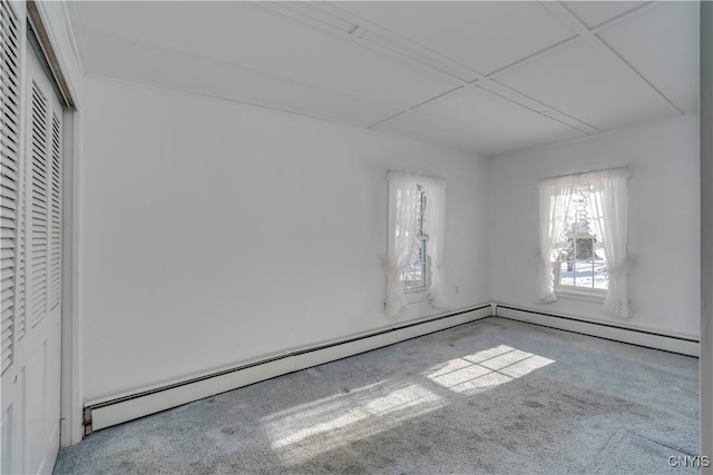 carpeted empty room with baseboard heating