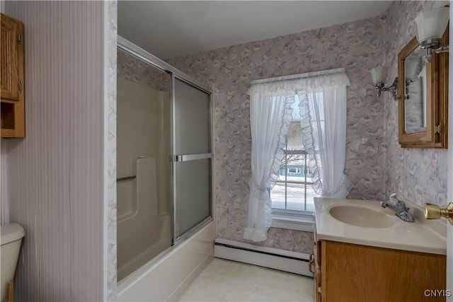 full bathroom with baseboard heating, vanity, toilet, and combined bath / shower with glass door