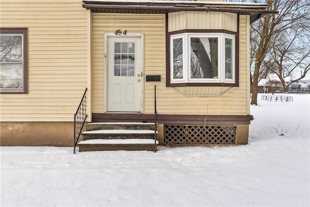 view of snow covered property entrance