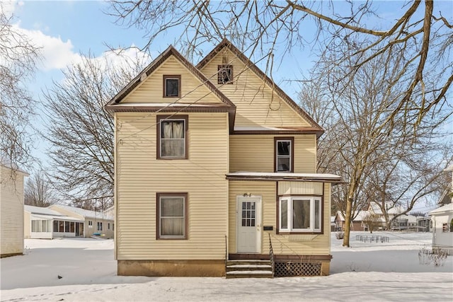 view of snow covered rear of property