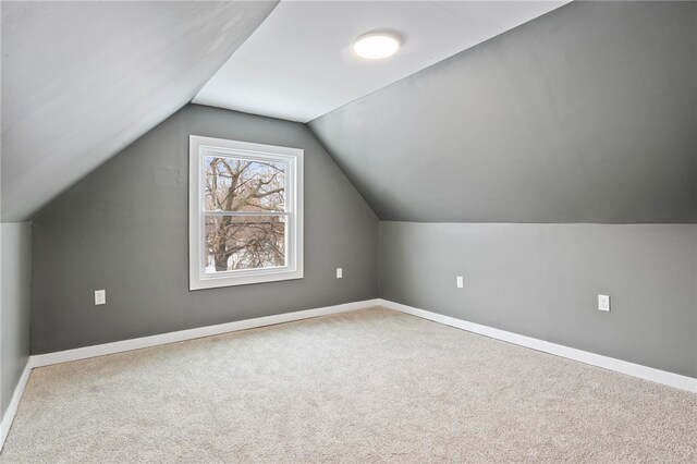 bonus room featuring lofted ceiling and carpet