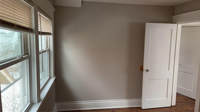 spare room with dark hardwood / wood-style flooring