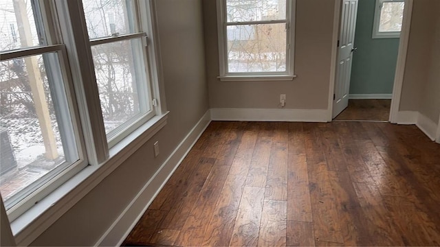 unfurnished room with dark hardwood / wood-style flooring