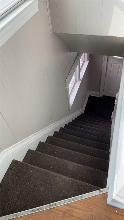 stairway with wood finished floors