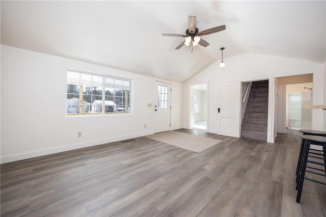 unfurnished living room with ceiling fan, dark hardwood / wood-style floors, and vaulted ceiling