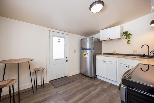 kitchen featuring white cabinetry, sink, dark hardwood / wood-style flooring, and appliances with stainless steel finishes