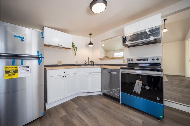 kitchen featuring sink, appliances with stainless steel finishes, white cabinets, dark hardwood / wood-style flooring, and decorative light fixtures