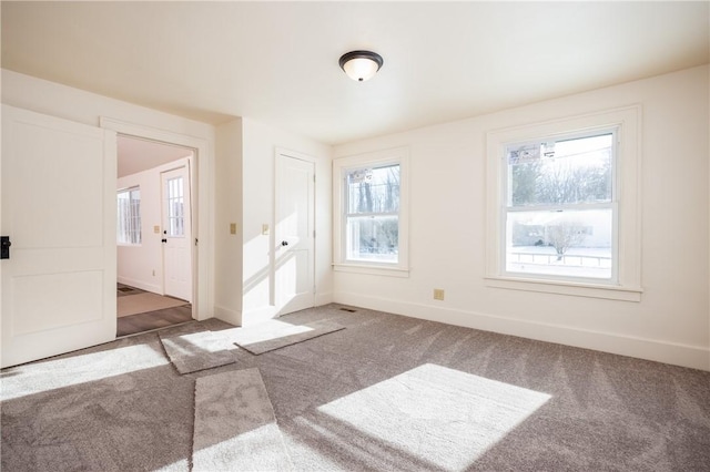 carpeted spare room with a wealth of natural light