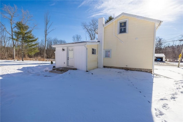 view of snow covered rear of property