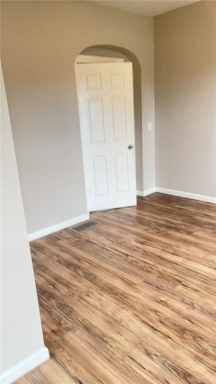 spare room featuring wood-type flooring