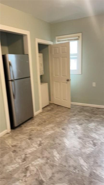 interior space featuring stainless steel refrigerator