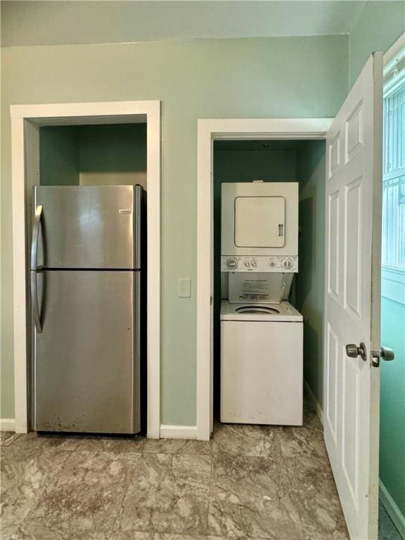 clothes washing area with stacked washer / drying machine