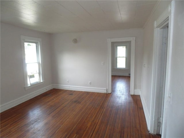 unfurnished room featuring plenty of natural light and dark hardwood / wood-style flooring