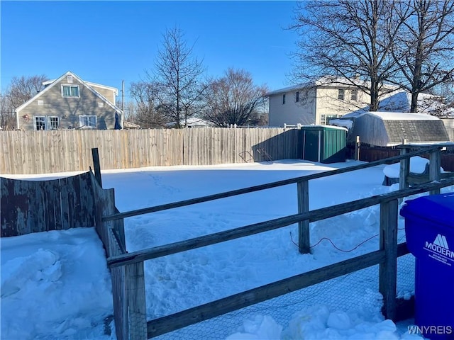 snowy yard with a shed