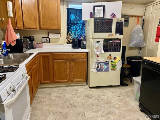 kitchen featuring sink and white appliances