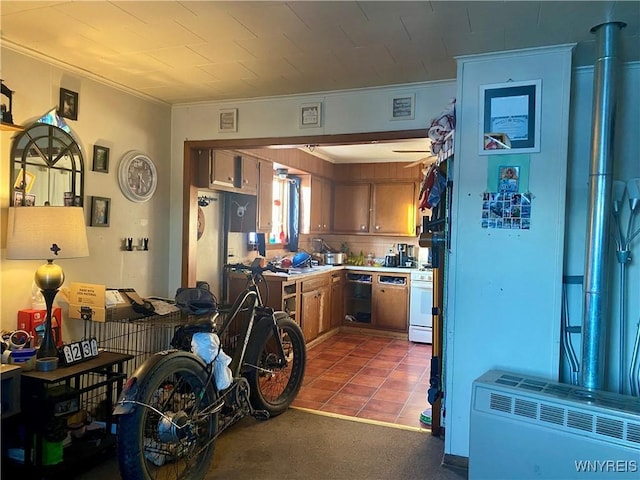 kitchen featuring tile patterned flooring, ornamental molding, dishwasher, and stainless steel refrigerator