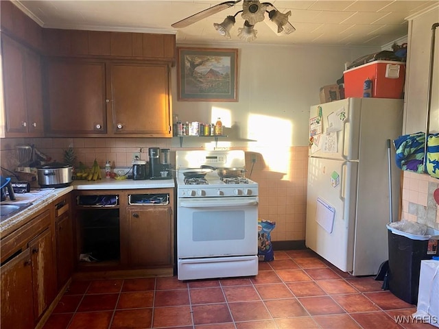 kitchen with dark tile patterned floors, ceiling fan, and white appliances