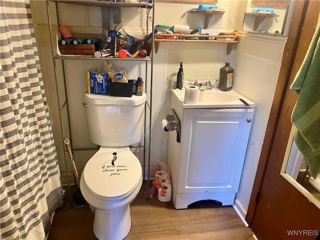 bathroom with vanity, hardwood / wood-style floors, curtained shower, and toilet