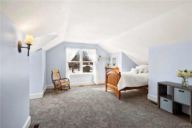 bedroom featuring lofted ceiling and dark carpet