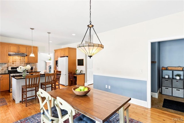 dining space with light wood-type flooring