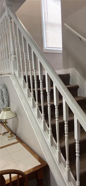 stairs featuring tile patterned flooring