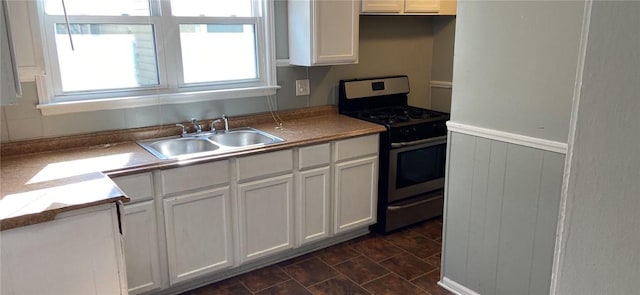 kitchen featuring white cabinetry, sink, and gas range