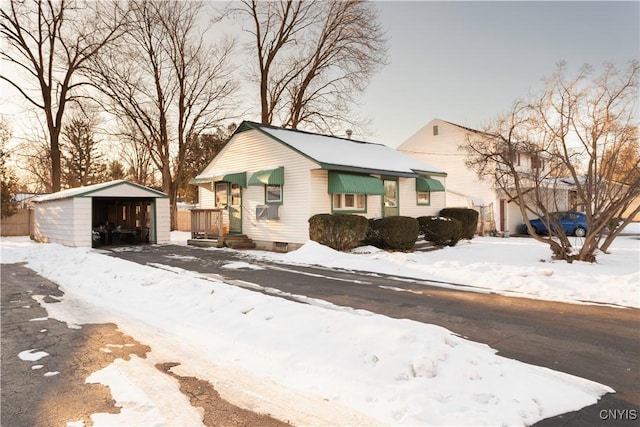 view of front of property with a garage and an outbuilding