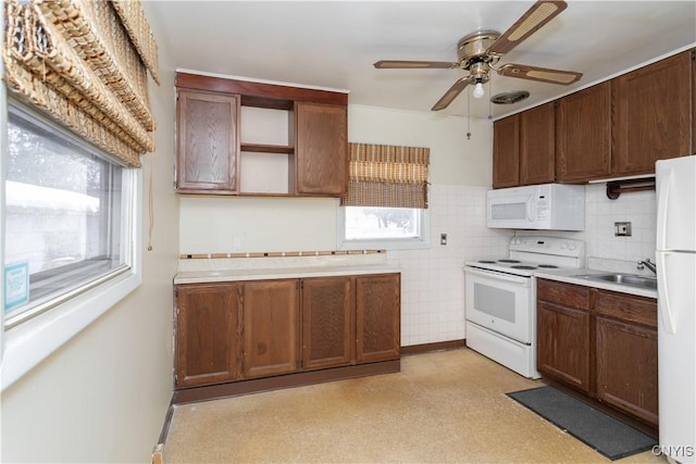 kitchen featuring ceiling fan, sink, and white appliances