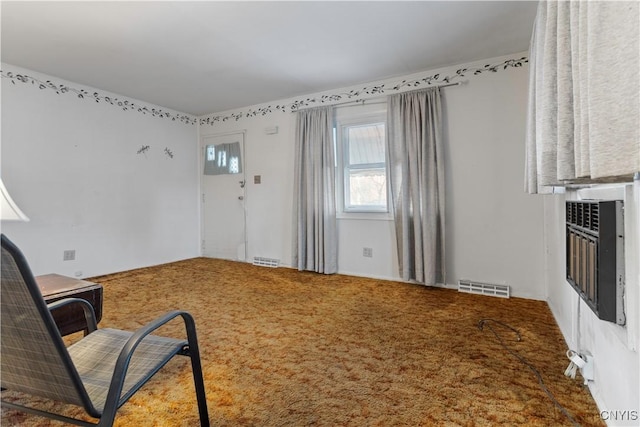 sitting room featuring carpet and heating unit