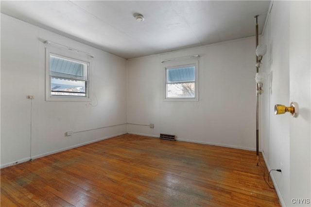 unfurnished room with wood-type flooring