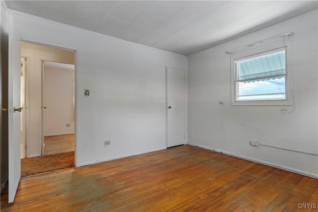 empty room with hardwood / wood-style flooring