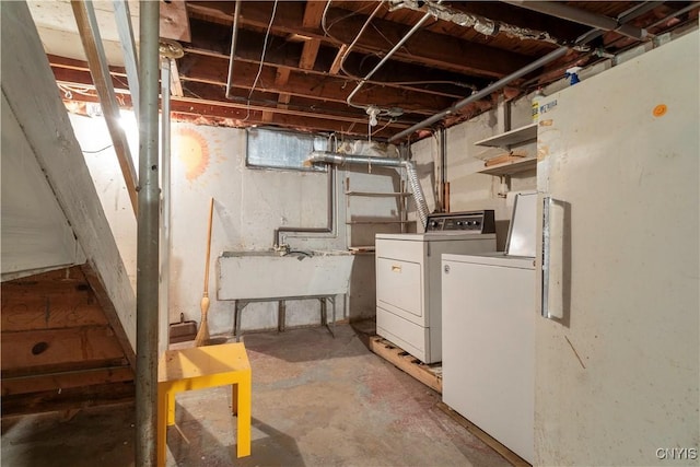 basement featuring independent washer and dryer and sink