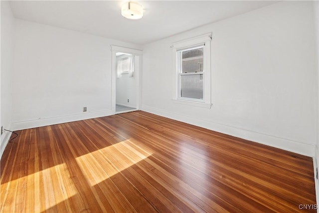 unfurnished room with hardwood / wood-style flooring