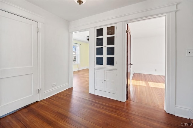 unfurnished room with dark hardwood / wood-style flooring