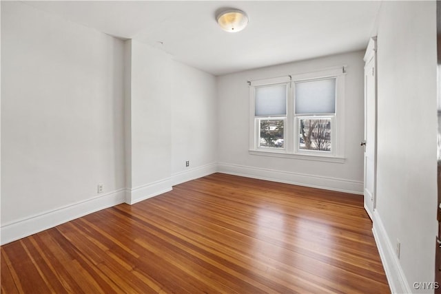 unfurnished room with hardwood / wood-style flooring