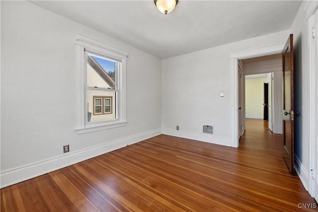 empty room featuring dark wood-type flooring