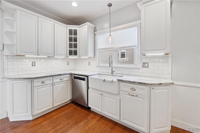 kitchen with pendant lighting, white cabinets, light hardwood / wood-style floors, and dishwasher