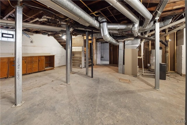 basement featuring electric water heater and heating unit