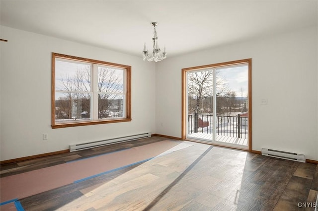 spare room with dark hardwood / wood-style flooring, a baseboard heating unit, and a chandelier