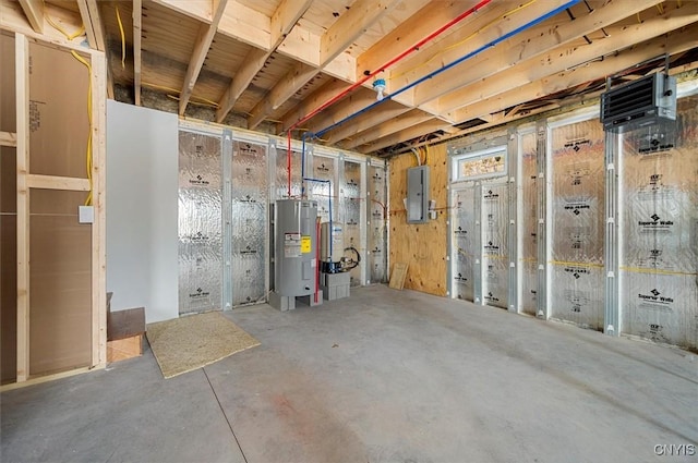 basement featuring electric panel and water heater