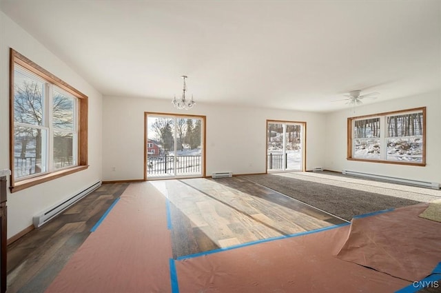 spare room with a chandelier, a wealth of natural light, and baseboard heating