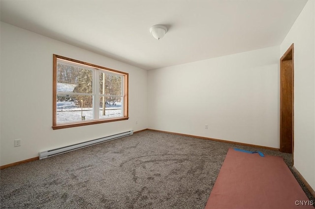 carpeted spare room with baseboard heating