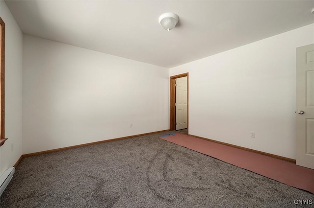 carpeted spare room with a baseboard radiator