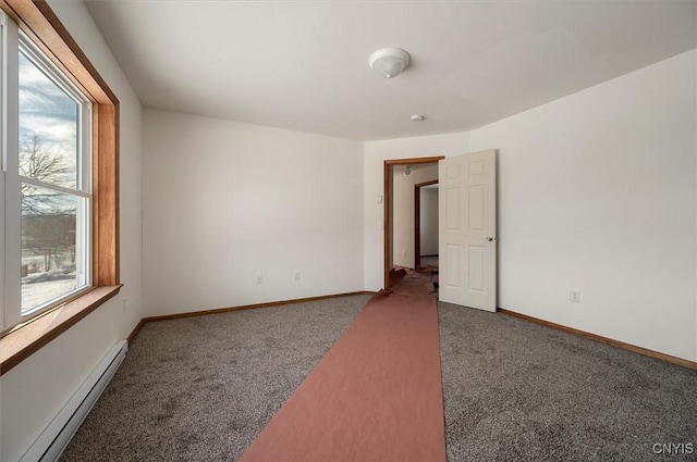 carpeted empty room with a healthy amount of sunlight and baseboard heating