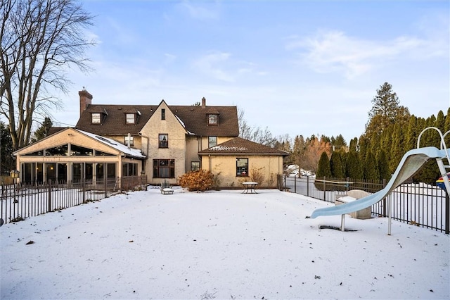 view of snow covered rear of property