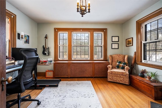 office with a chandelier and light hardwood / wood-style floors